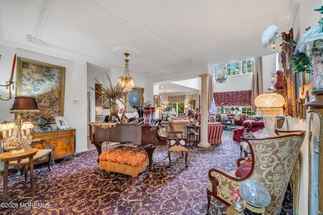 living area featuring carpet flooring, crown molding, and ornate columns