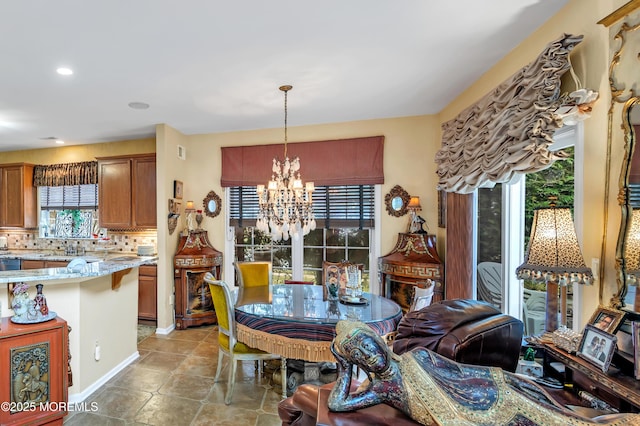 dining area featuring light tile patterned floors, recessed lighting, and a chandelier