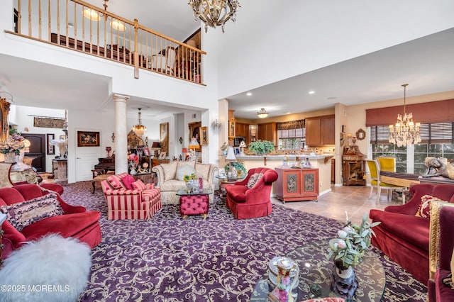 living room featuring a chandelier, light tile patterned floors, a healthy amount of sunlight, and decorative columns