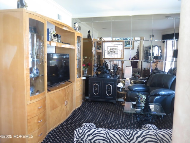 carpeted living area with visible vents and ornamental molding