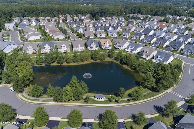 drone / aerial view with a residential view and a water view