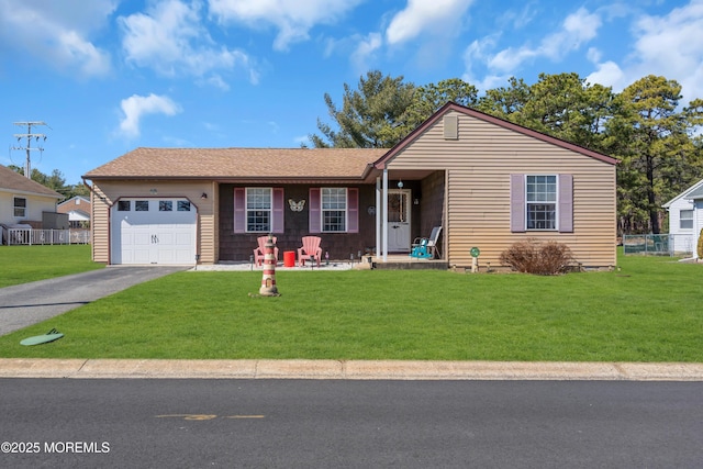 single story home with a garage, driveway, and a front lawn