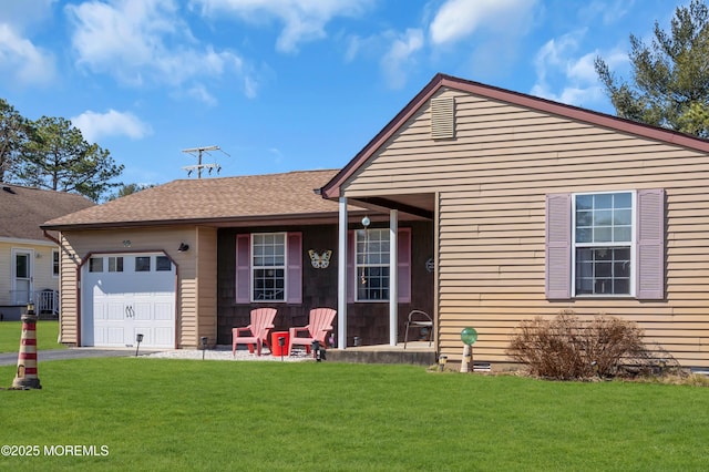 view of front facade with a front lawn, roof with shingles, and an attached garage