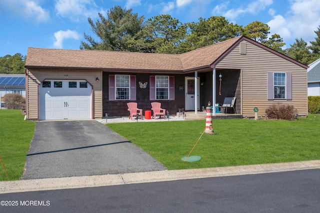 ranch-style house with an attached garage, covered porch, a shingled roof, a front lawn, and aphalt driveway