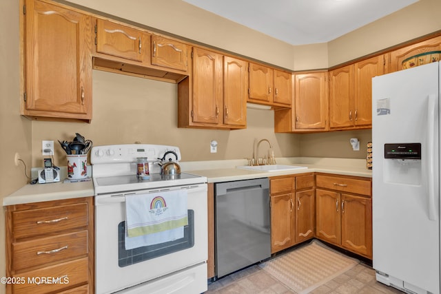 kitchen featuring white appliances, brown cabinetry, light floors, a sink, and light countertops