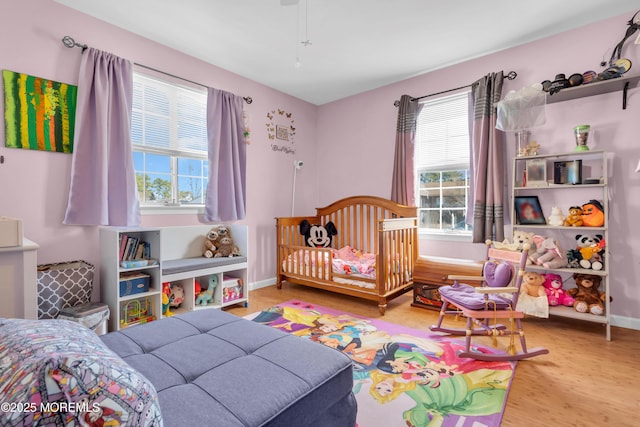 bedroom featuring baseboards and wood finished floors