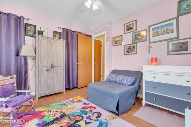 bedroom with baseboards, ceiling fan, and wood finished floors