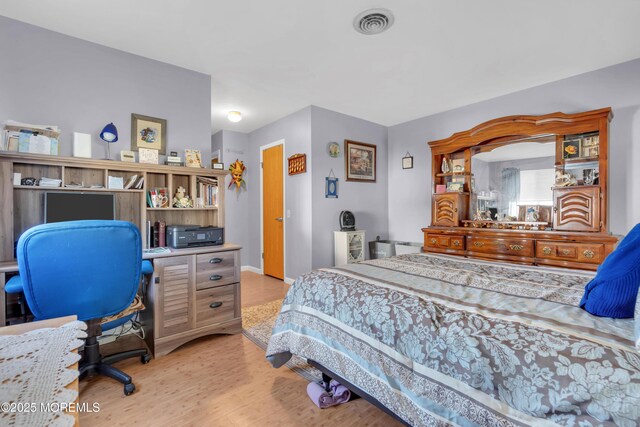 bedroom featuring light wood-type flooring and visible vents