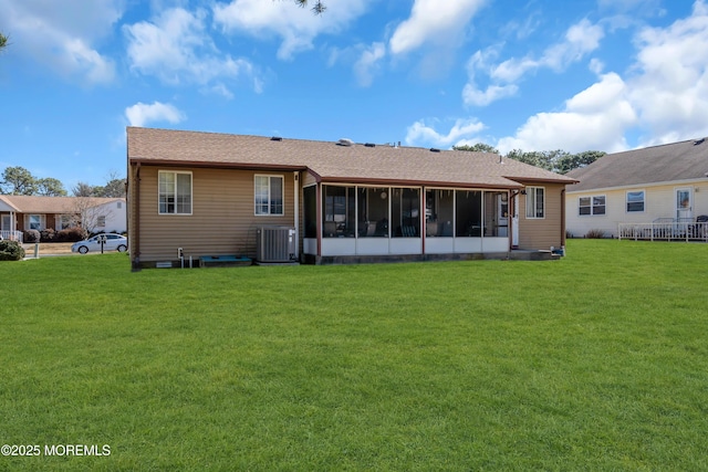 back of house featuring a yard, central AC unit, and a sunroom