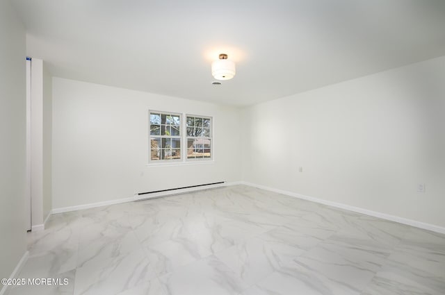 spare room with marble finish floor, baseboards, and baseboard heating