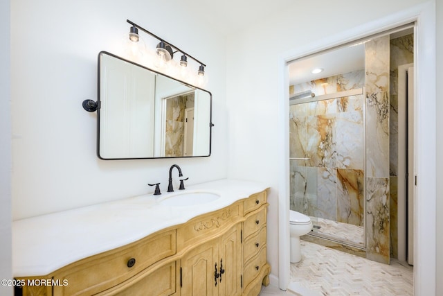 full bathroom featuring a marble finish shower, toilet, and vanity