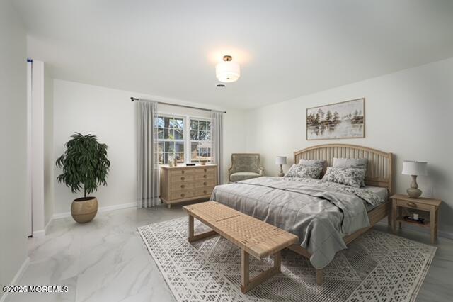 bedroom with marble finish floor and baseboards