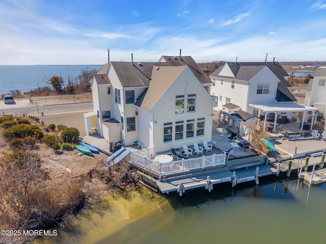 rear view of property with a deck with water view