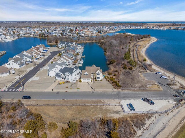 drone / aerial view featuring a residential view and a water view