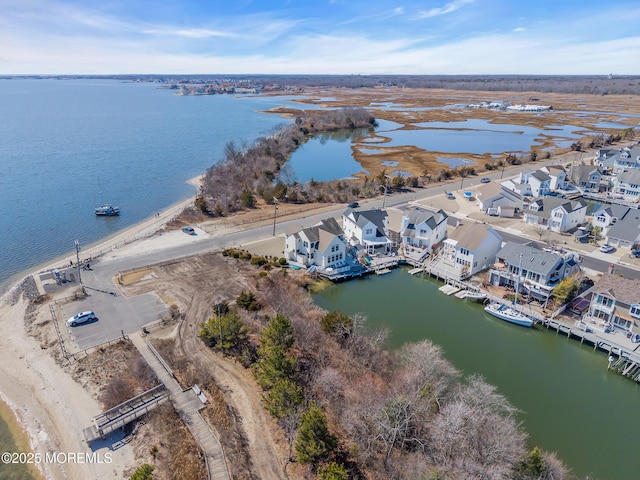 birds eye view of property with a water view and a residential view