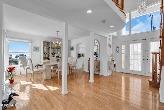 entryway with recessed lighting, baseboards, light wood finished floors, and a chandelier