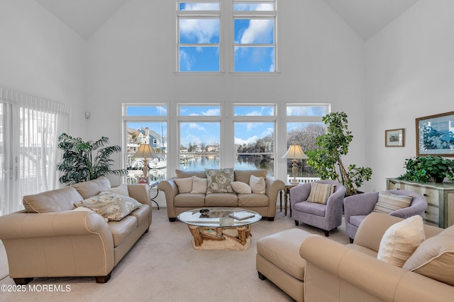 living room featuring a water view, carpet flooring, and vaulted ceiling