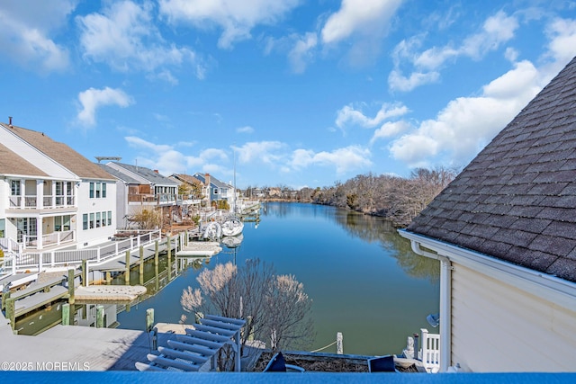 dock area featuring a residential view and a water view