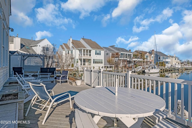 wooden terrace with a residential view and a water view