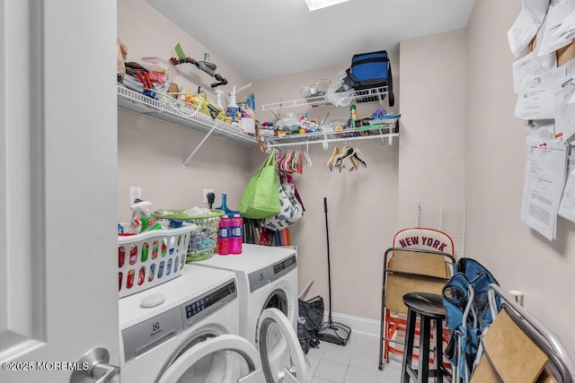 laundry room featuring tile patterned flooring, laundry area, and washer and clothes dryer