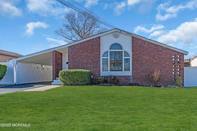 view of front of property with a front lawn, brick siding, and driveway