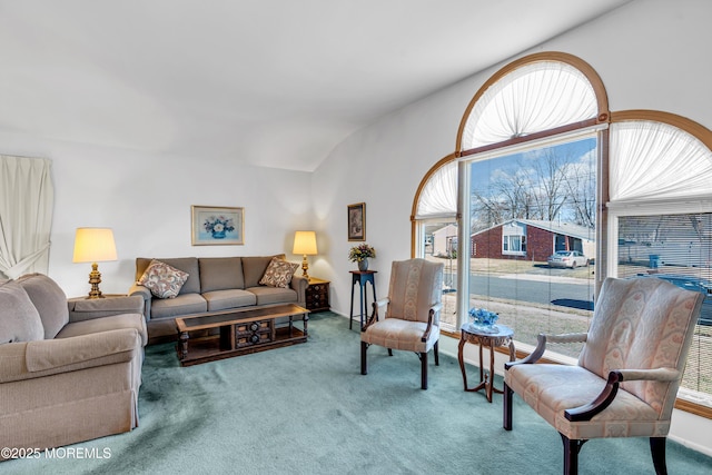 living area with lofted ceiling and carpet flooring