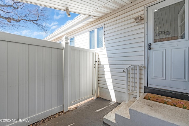 view of exterior entry featuring fence