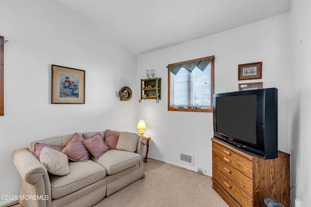 living area with visible vents, lofted ceiling, carpet, and baseboards