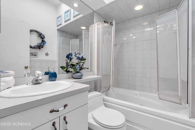 full bath featuring recessed lighting, toilet, vanity, and washtub / shower combination