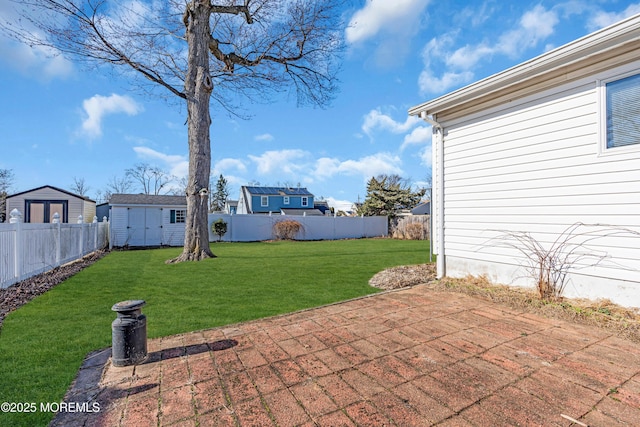 view of patio featuring an outbuilding, a shed, and a fenced backyard