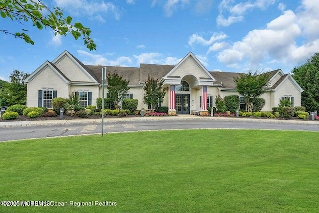 view of front of property featuring a front yard and french doors