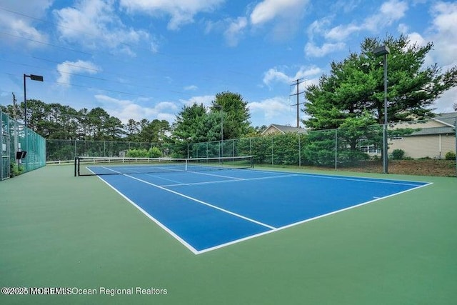 view of tennis court with fence