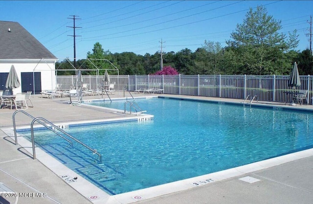 pool featuring a patio and fence