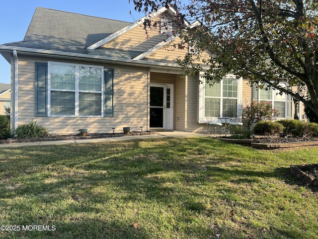 view of front of home with a front lawn and roof with shingles