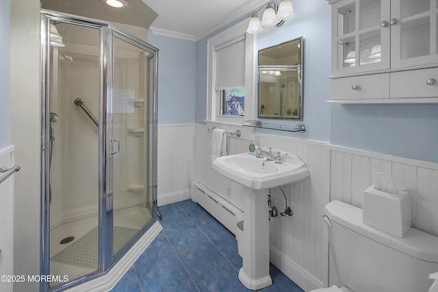 full bath featuring a shower stall, wainscoting, a baseboard heating unit, tile patterned floors, and toilet