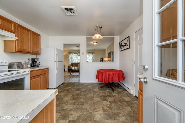 kitchen with visible vents, under cabinet range hood, light countertops, baseboard heating, and white appliances