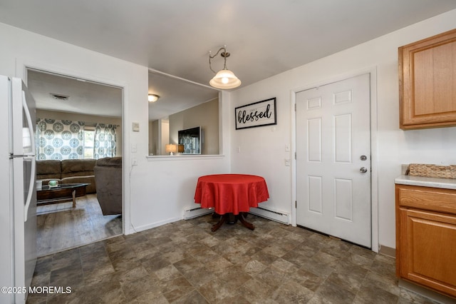 dining room featuring a baseboard heating unit, baseboards, a baseboard radiator, and stone finish flooring