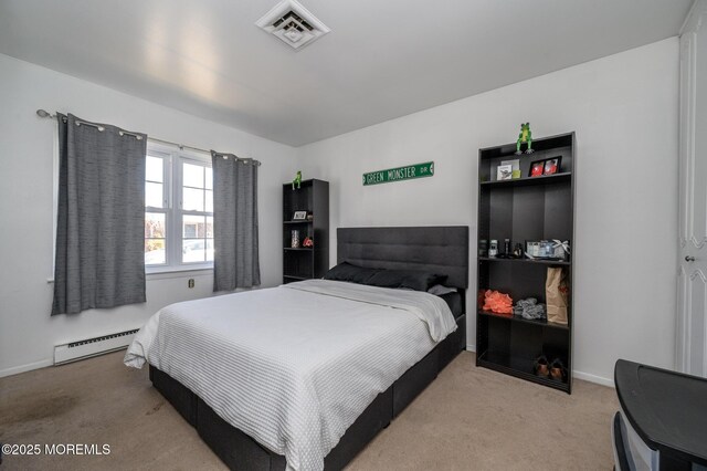 bedroom with a baseboard heating unit, carpet flooring, baseboards, and visible vents