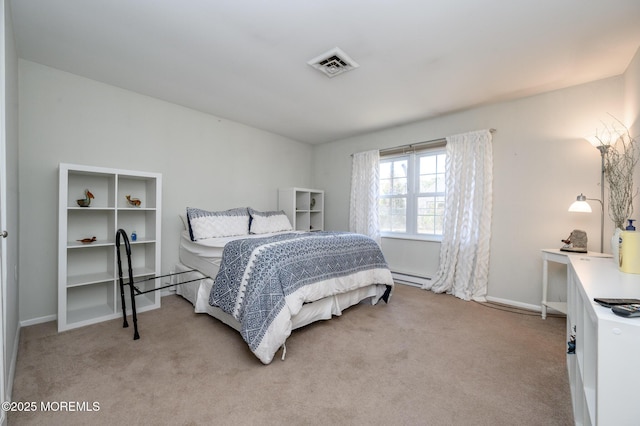 bedroom with visible vents, light carpet, baseboard heating, and baseboards