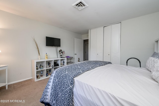 carpeted bedroom with a closet, visible vents, and baseboards