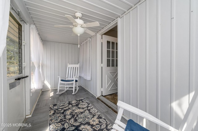 sunroom / solarium featuring ceiling fan