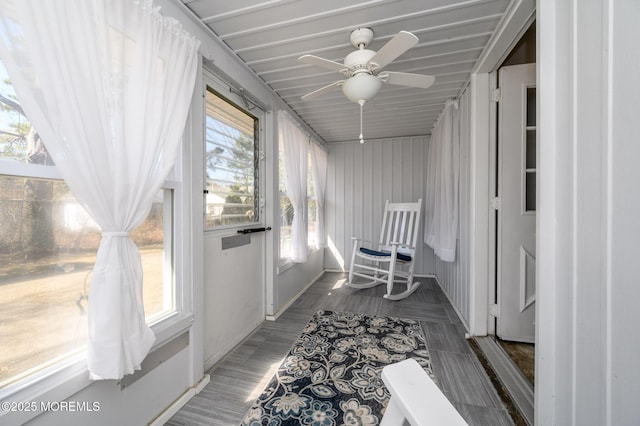 sunroom / solarium featuring ceiling fan