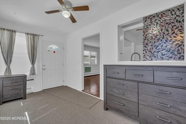 entryway with a baseboard heating unit and ceiling fan