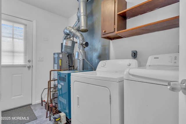 washroom with washer and clothes dryer and cabinet space