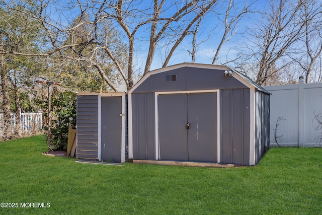 view of shed with a fenced backyard