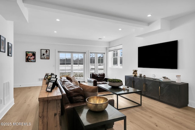 living room with visible vents, baseboards, beamed ceiling, recessed lighting, and light wood-style floors