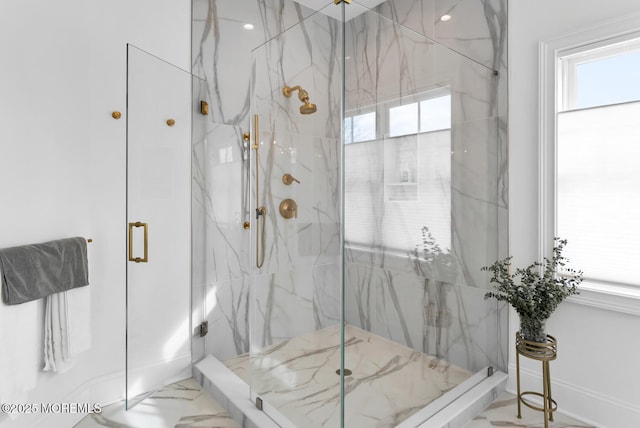 bathroom featuring a marble finish shower, baseboards, and marble finish floor