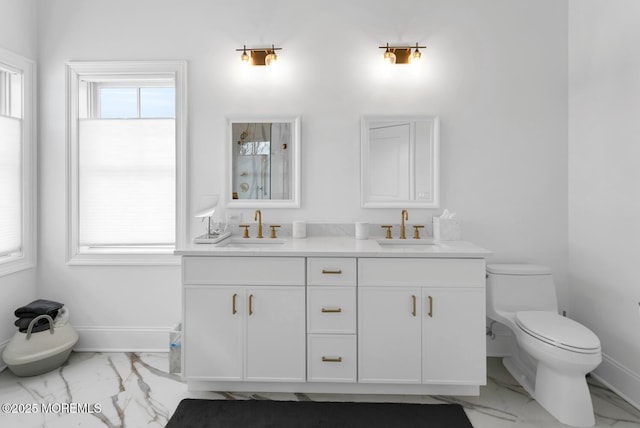 full bathroom with a sink, baseboards, and marble finish floor