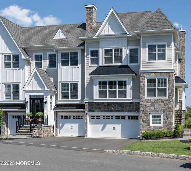 107 Eagle Way, Eatontown, NJ 07724 - view of front of house featuring board and batten siding, stone siding, and asphalt driveway