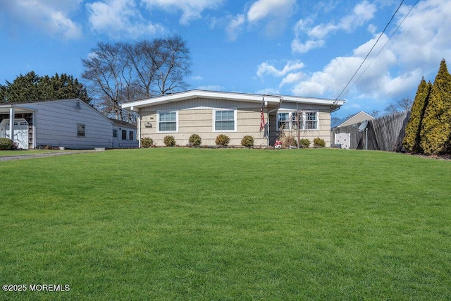 ranch-style home featuring a front lawn and fence